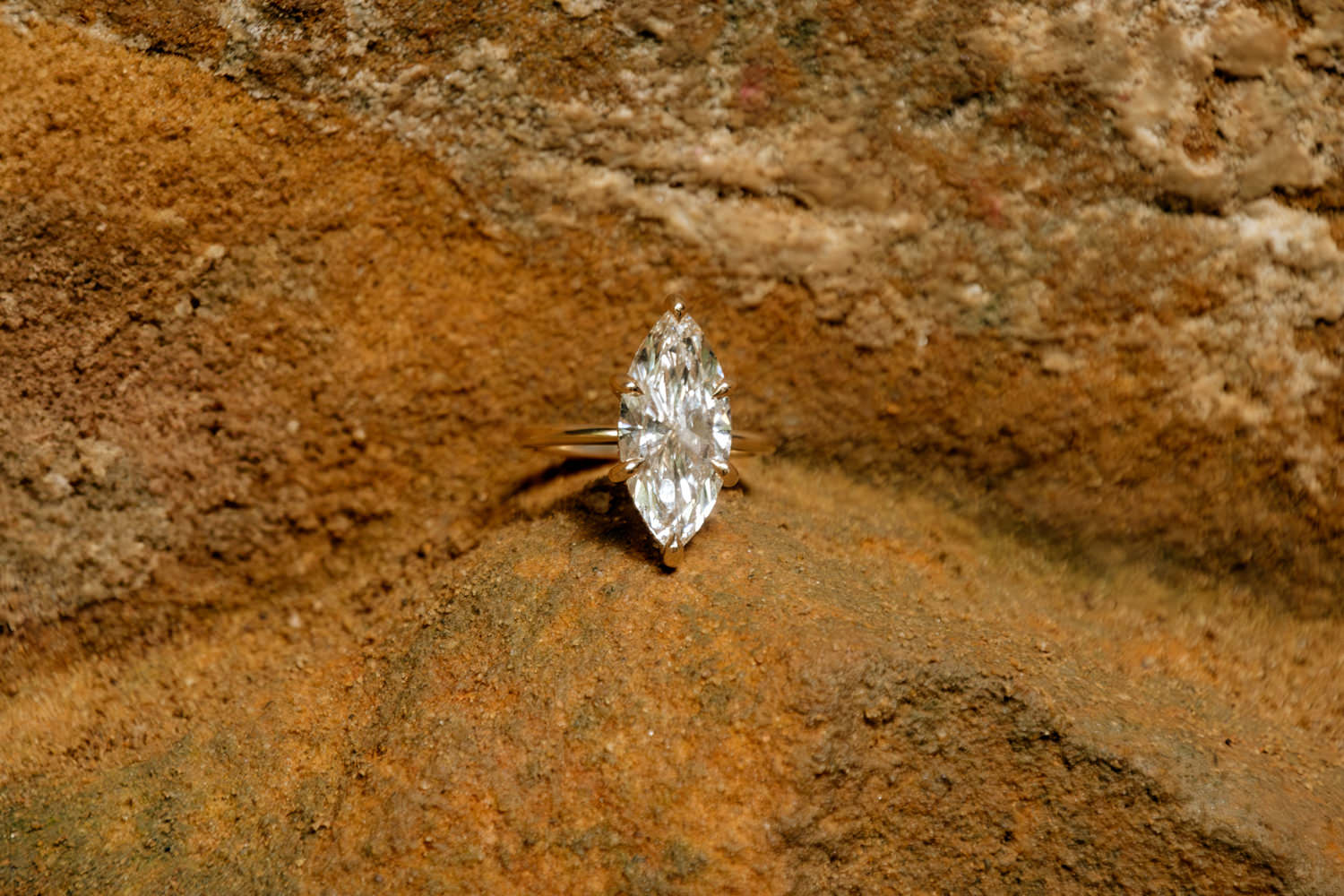 A unique engagement ring sits on an orange piece of sandstone at Ash Cave.
