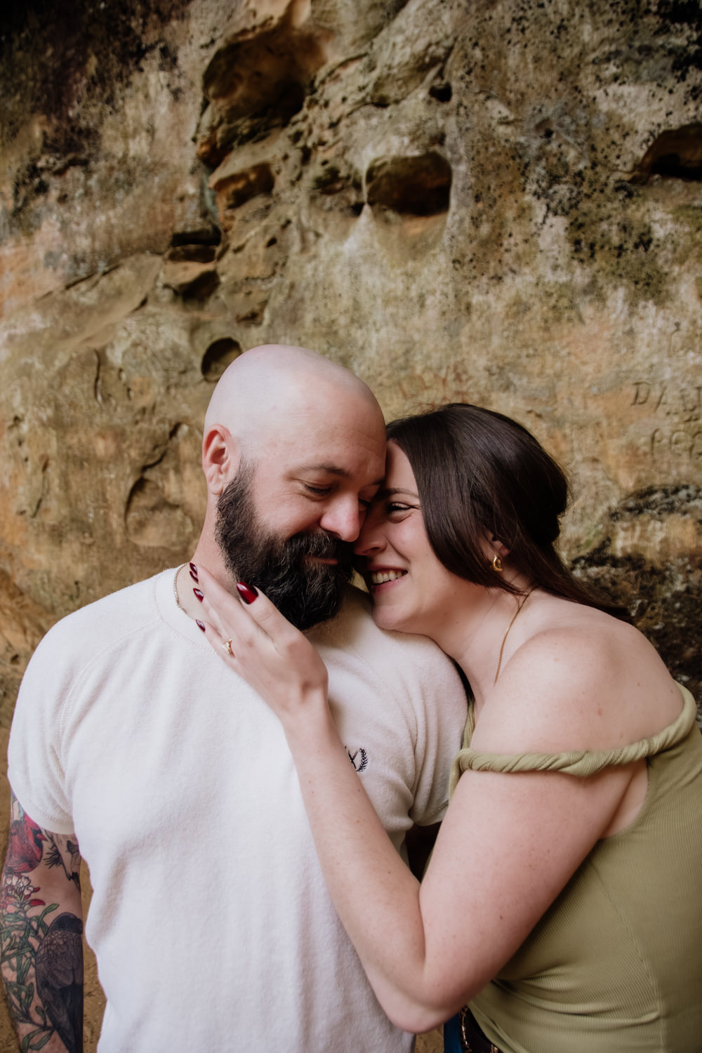 A woman leans into a man after he proposed to her in the Hocking Hills.