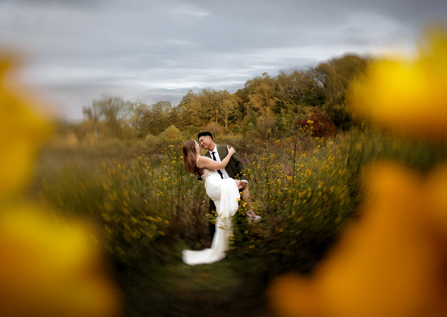 Artistic motion blurred and layered photo of a couple dip kissing in a wildflower field in the Hocking Hills.