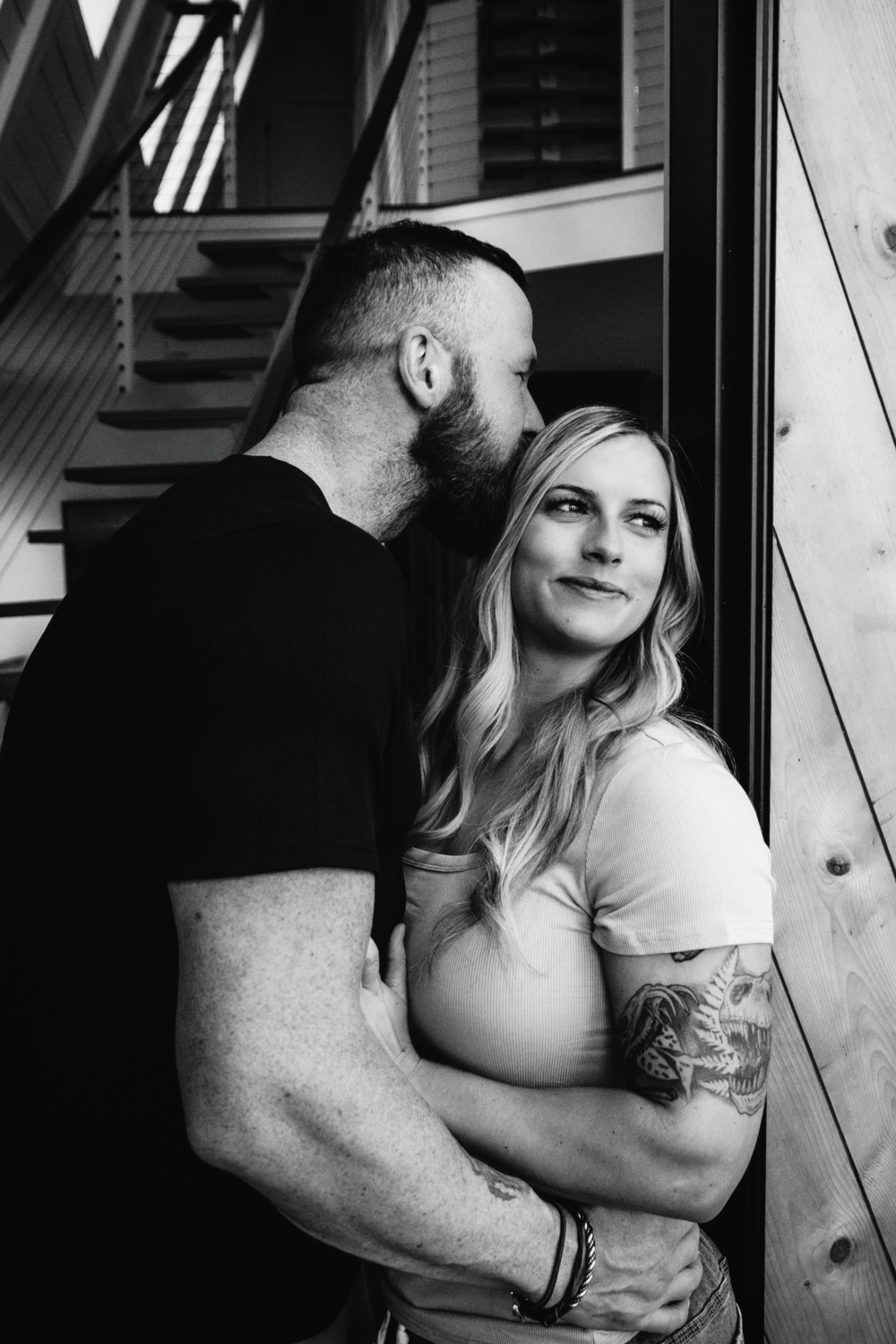A woman and man pose on the balcony of an A-frame cabin in Ohio for their anniversary portraits. They traveled from North Dakota for their photo session.
