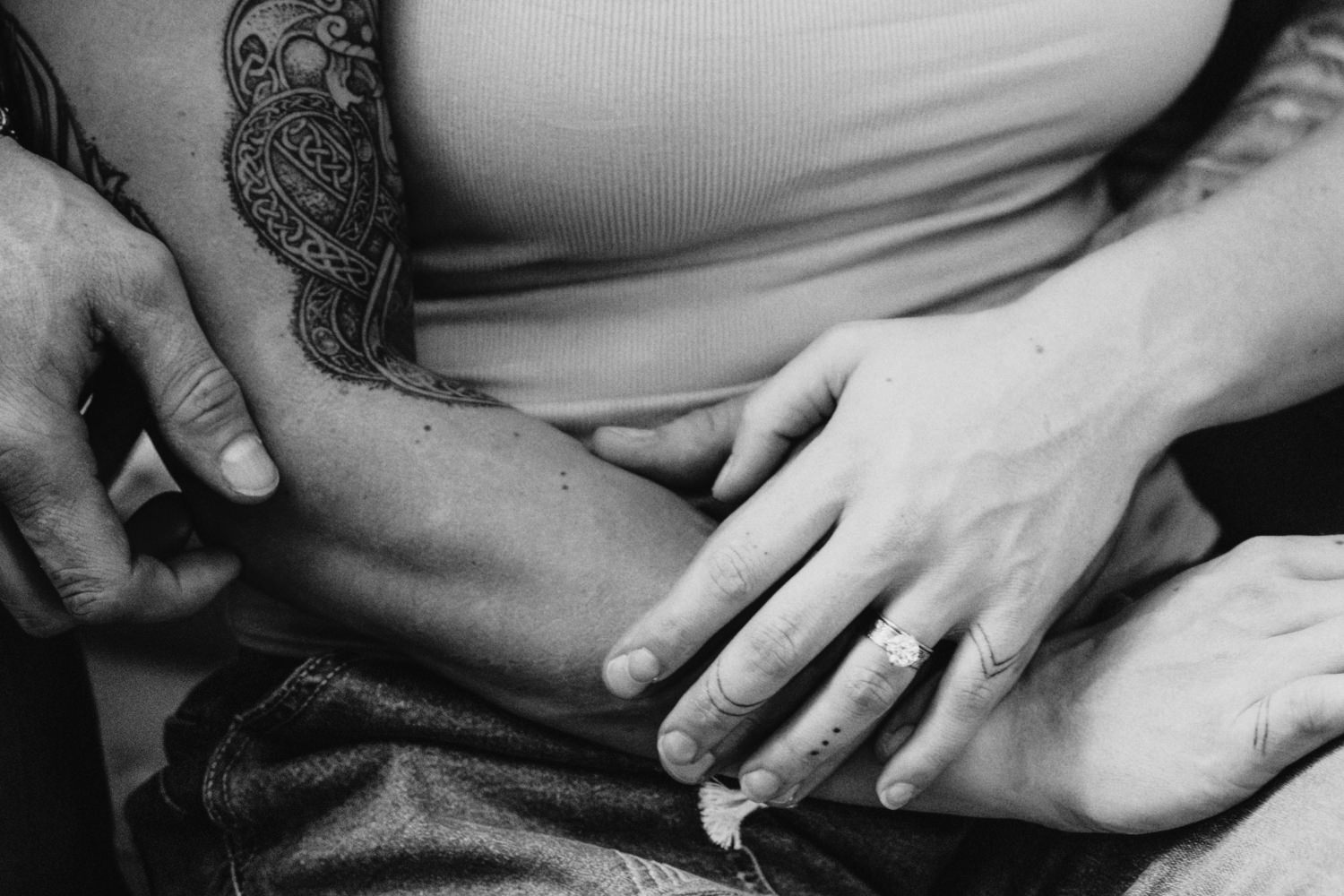 Close up black and white photo of a man and woman's hands intertwined as they celebrate their 5th wedding anniversary with a portrait session.