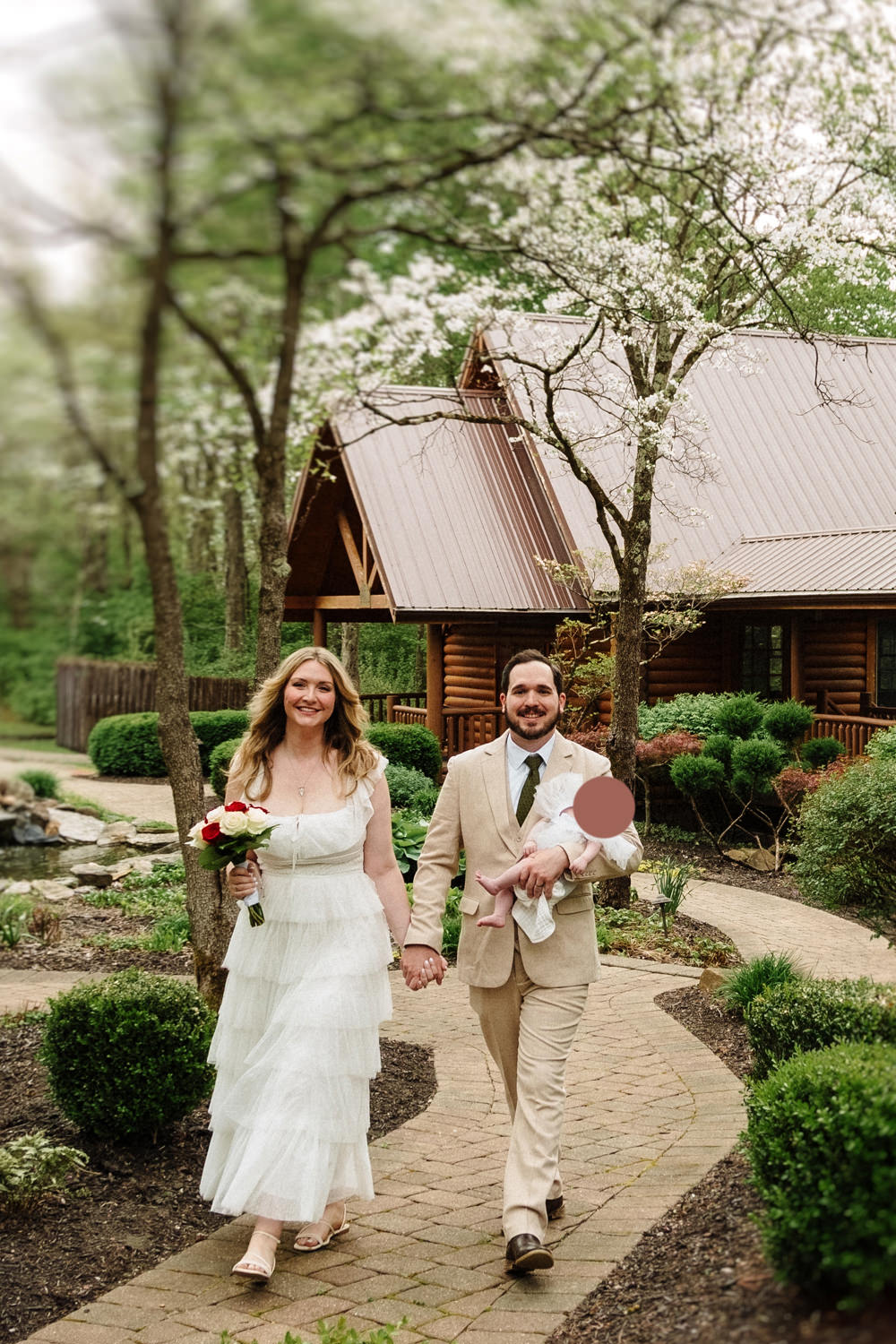 A couple with their infant daughter renew their vows at Hocking Hills Wedding Chapel on their fifth anniversary.
