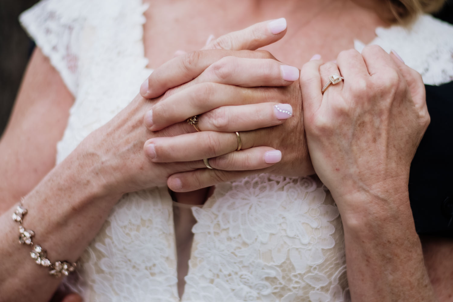 An older couple in their 60s holds hands at their 35th wedding anniversary vow renewal at Ravenwood Castle.