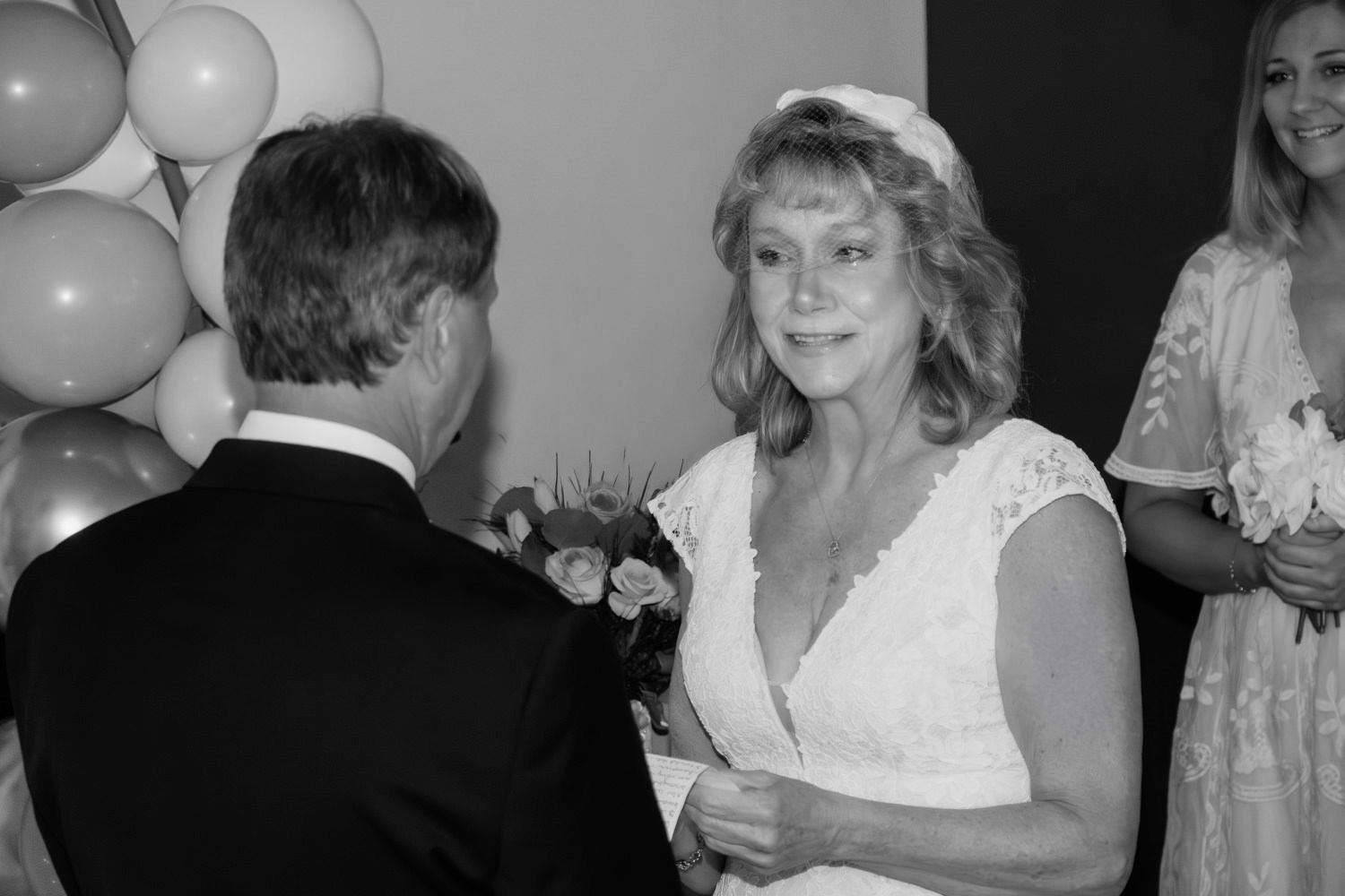 A teary eyed woman recites her vows at her 35th wedding anniversary vow renewal.