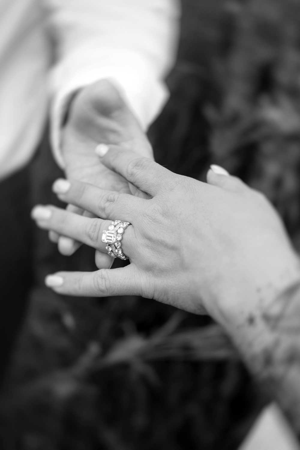 A motion blurred artistic photo of women's hands touching during a lesbian vow renewal on the couple's first anniversary.