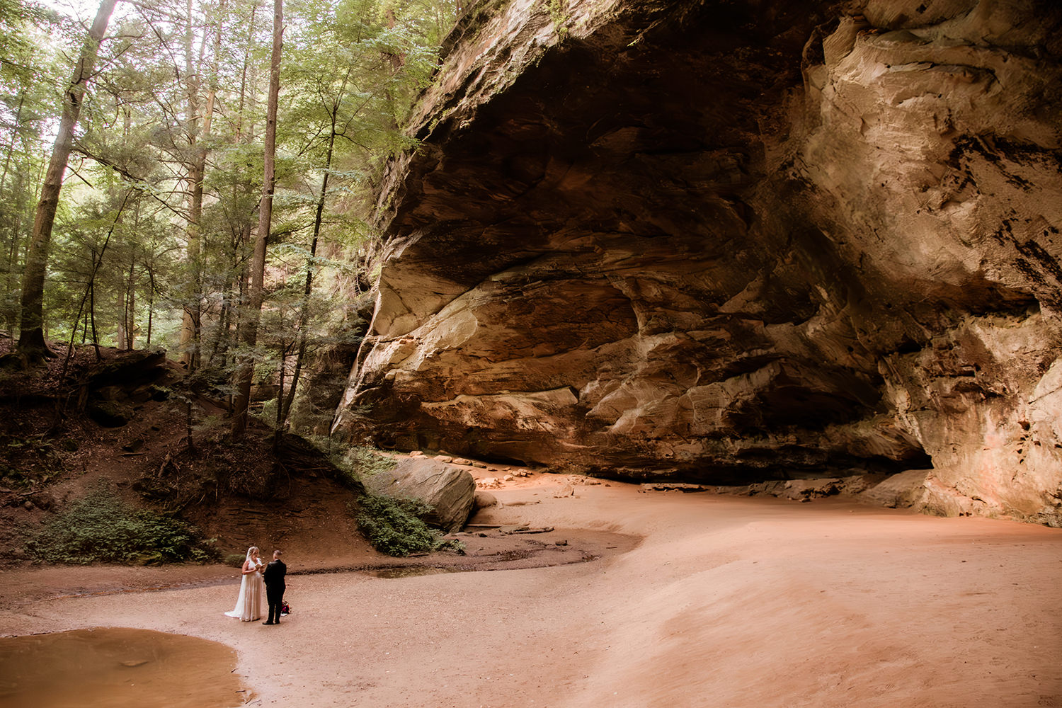 Epic wide angle shot of Ash Cave during a Queer Anniversary Vow Renewal in the Hocking Hills.