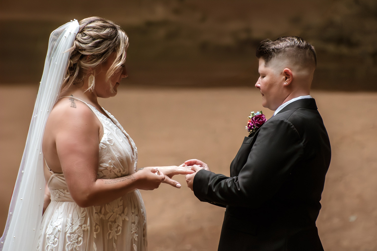 A queer couple exchanges rings during their private vows at Ash Cave.