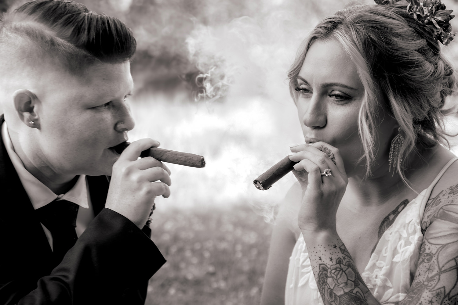Two brides smoke cigars on their vow renewal anniversary session.