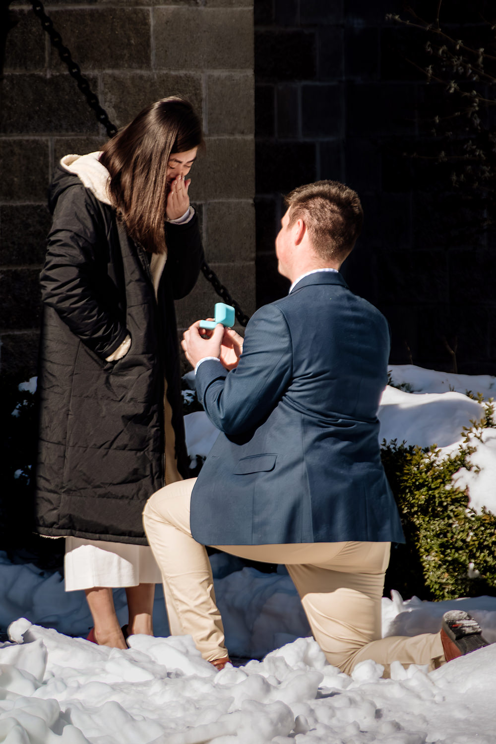 A man proposes on the drawbridge at Ravenwood Castle in winter following a magical surprise proposal.