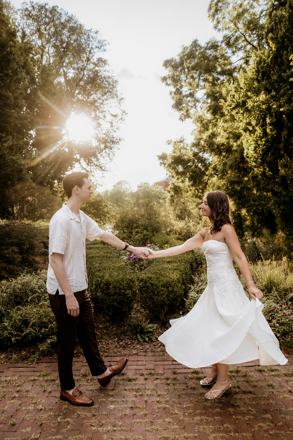 A man and woman dancing in Schiller Park as the sun sets behind them.