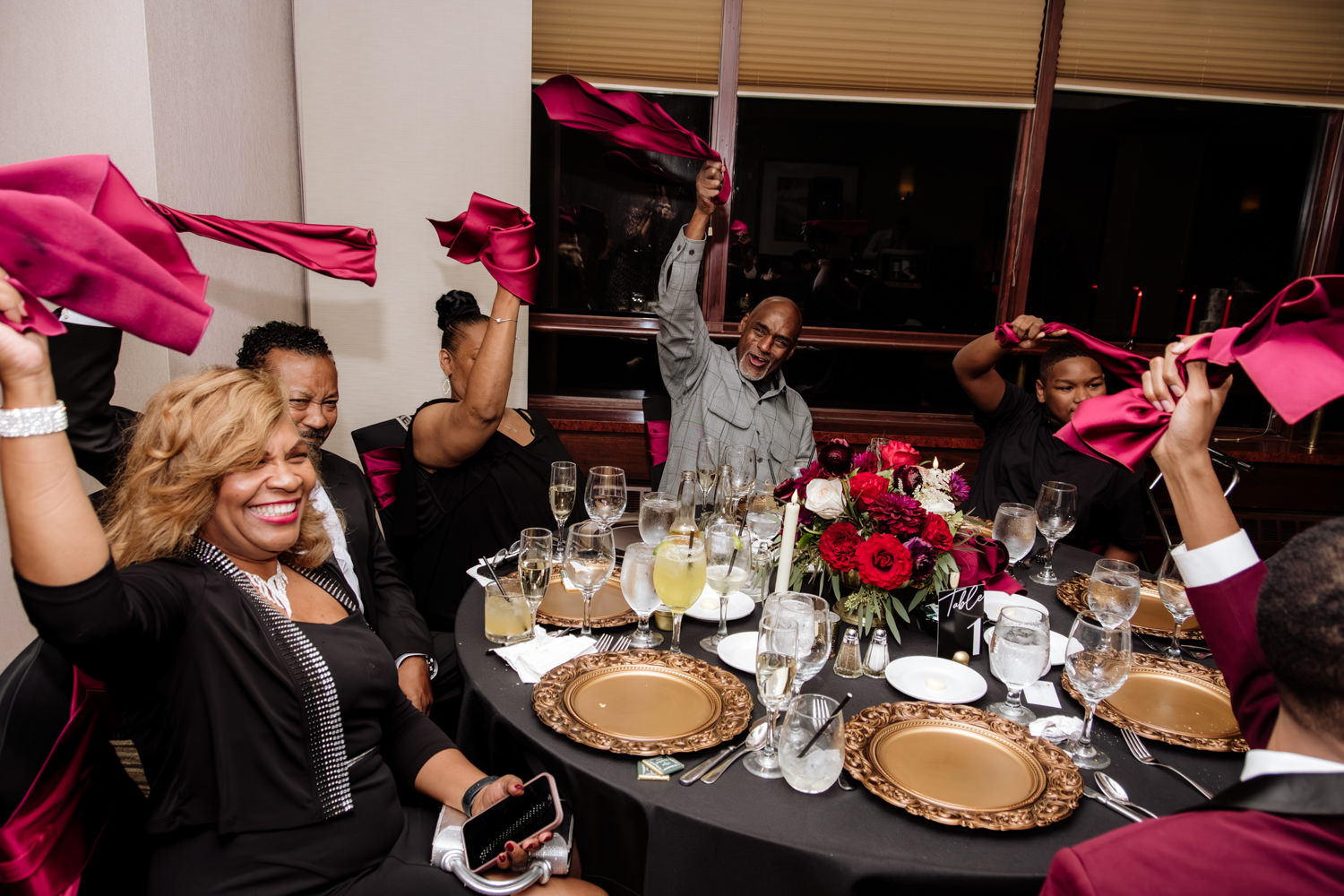 A black family waves red napkins during a wedding reception in Akron, Ohio.
