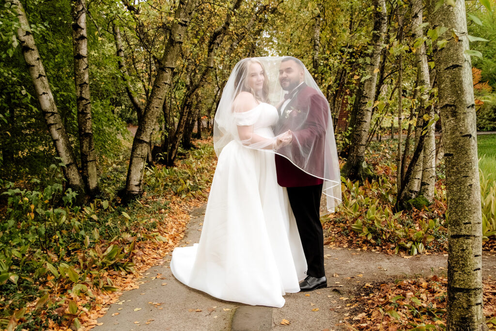 Rainy day wedding portrait at Stan Hywet Hall and Gardens Conservatory in the English Garden.