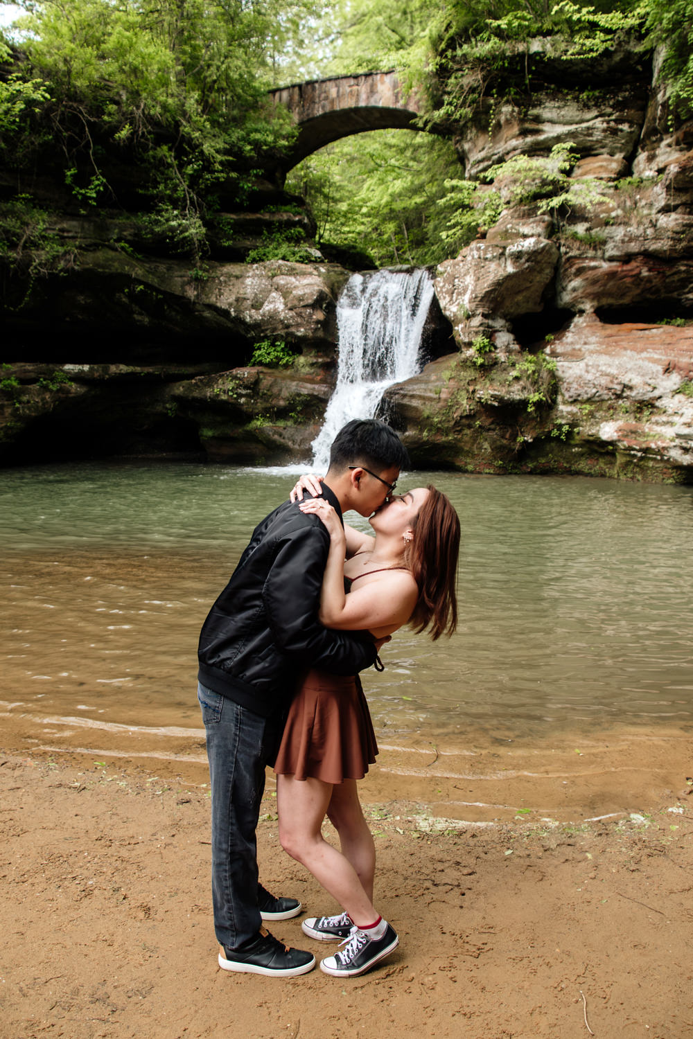 A couple celebrates after after a Hocking Hills surprise proposal.