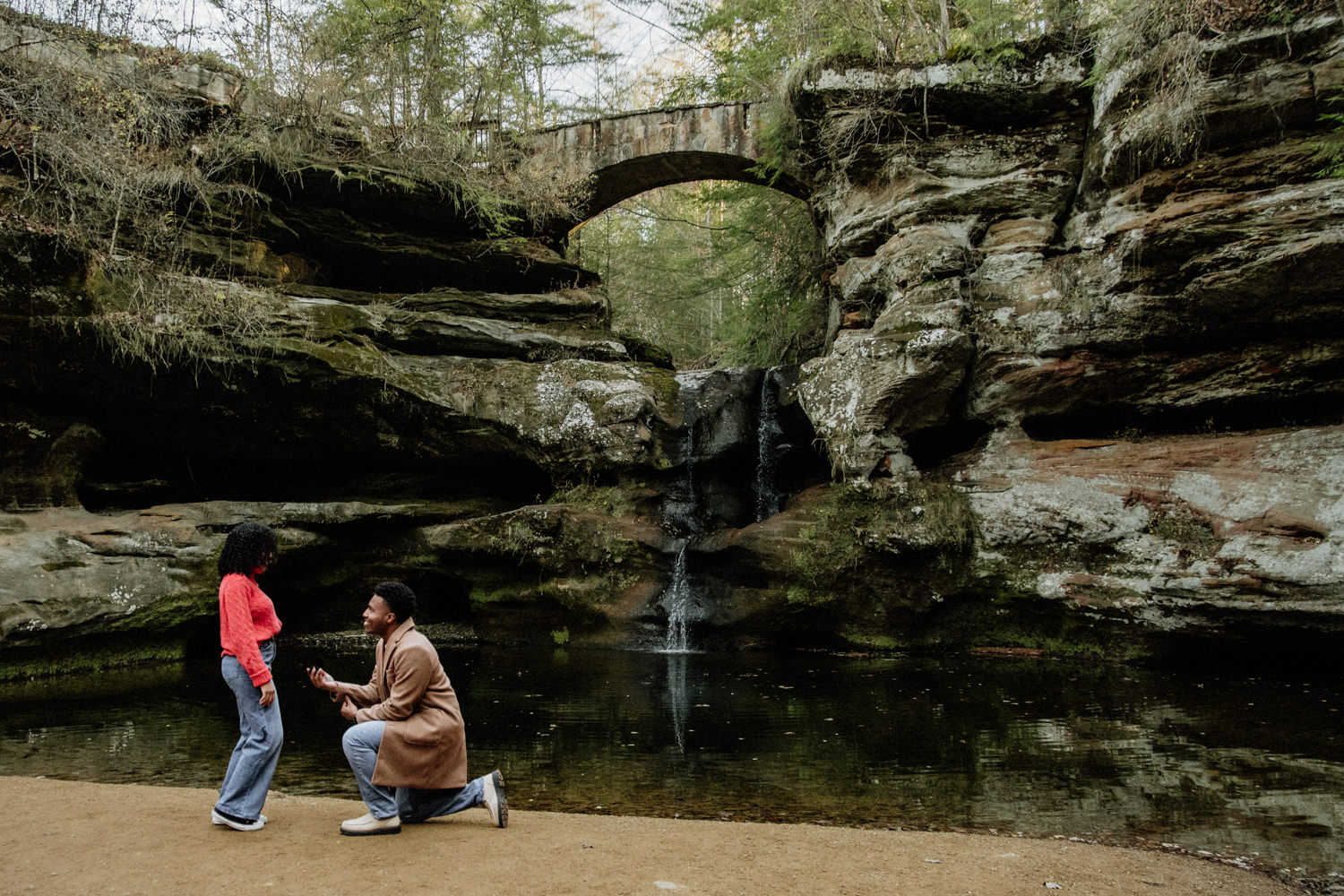 A black man proposes to a black woman at Upper Falls at Old Man's Cave.