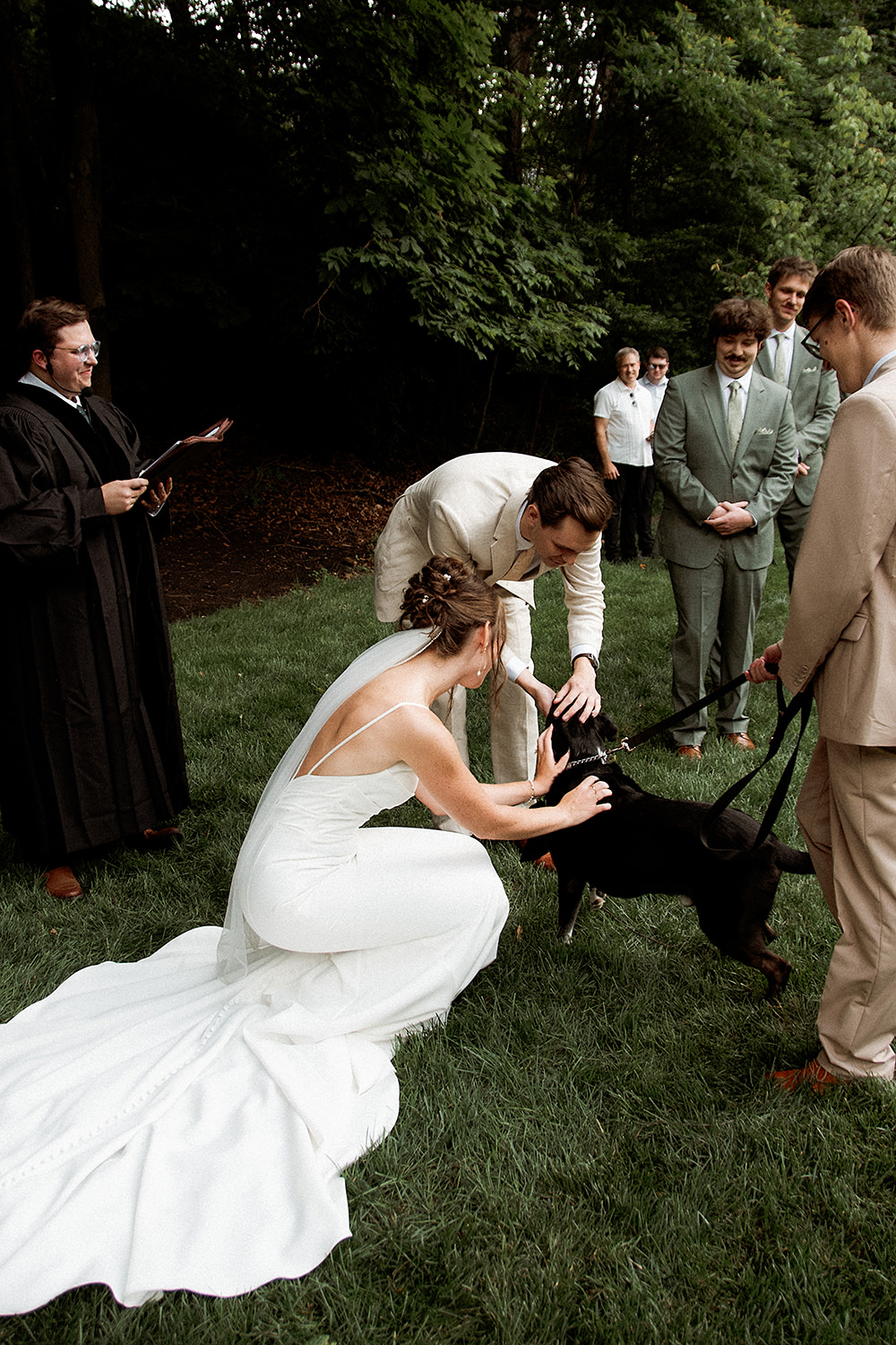 A dog ring bearer greets his human parents during their Crockett's Run wedding ceremony.
