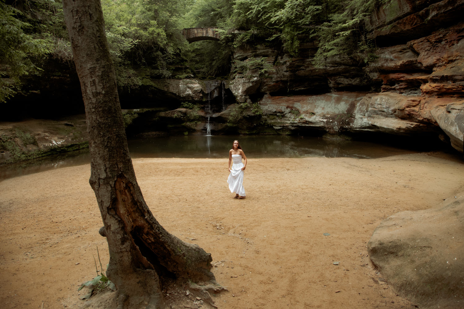 Candid shot of a high school senior laughing while walking through a Hocking Hills forest