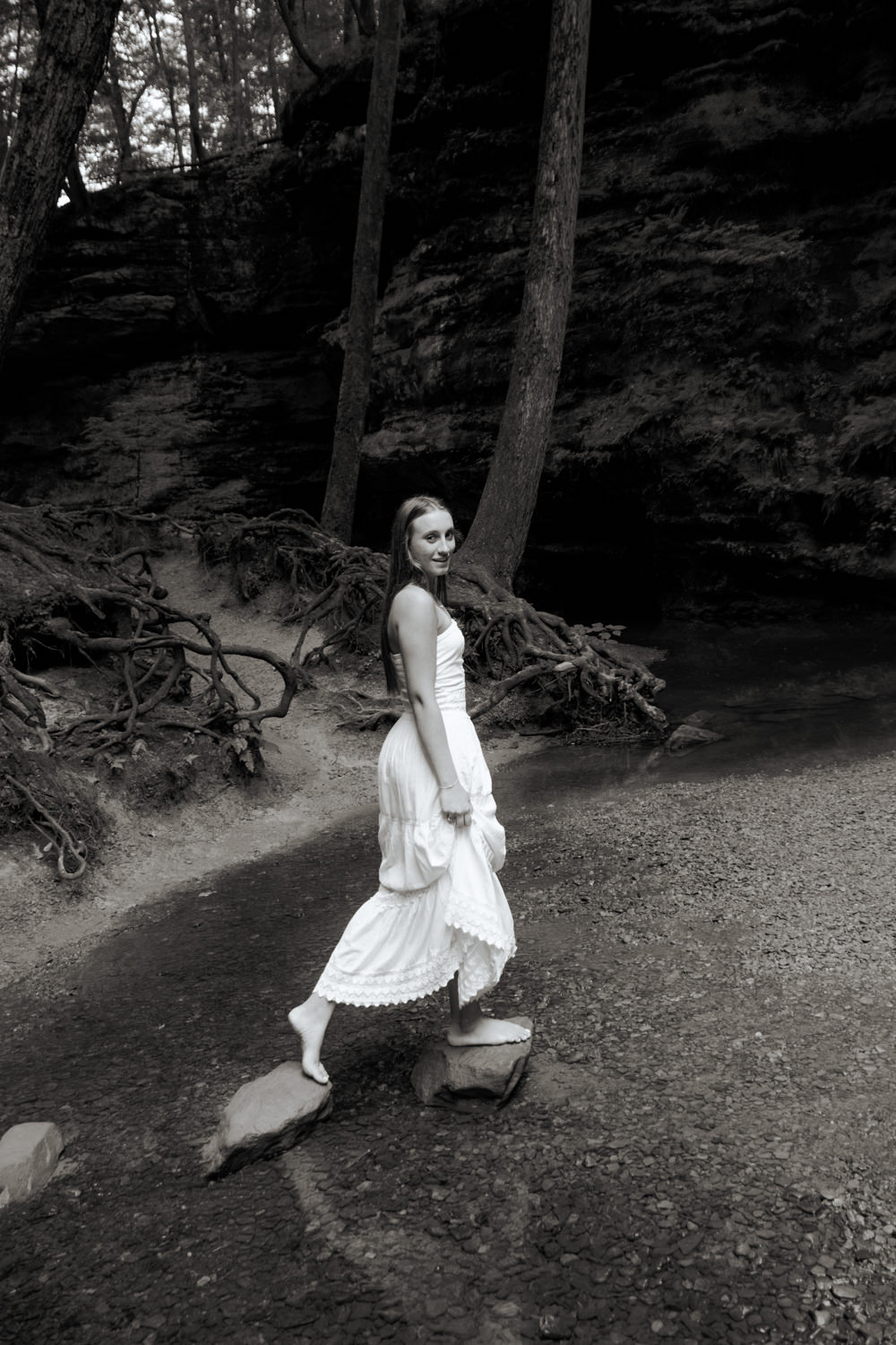 Senior girl exploring the rocky gorge path at Old Man’s Cave during a morning photo session