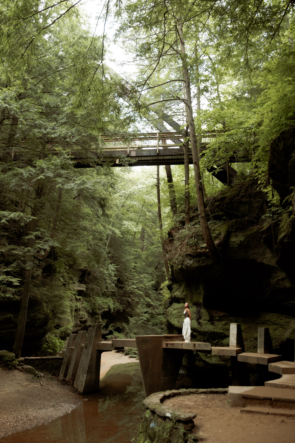 Senior girl casually walking along a sunlit nature trail in Hocking Hills State Park