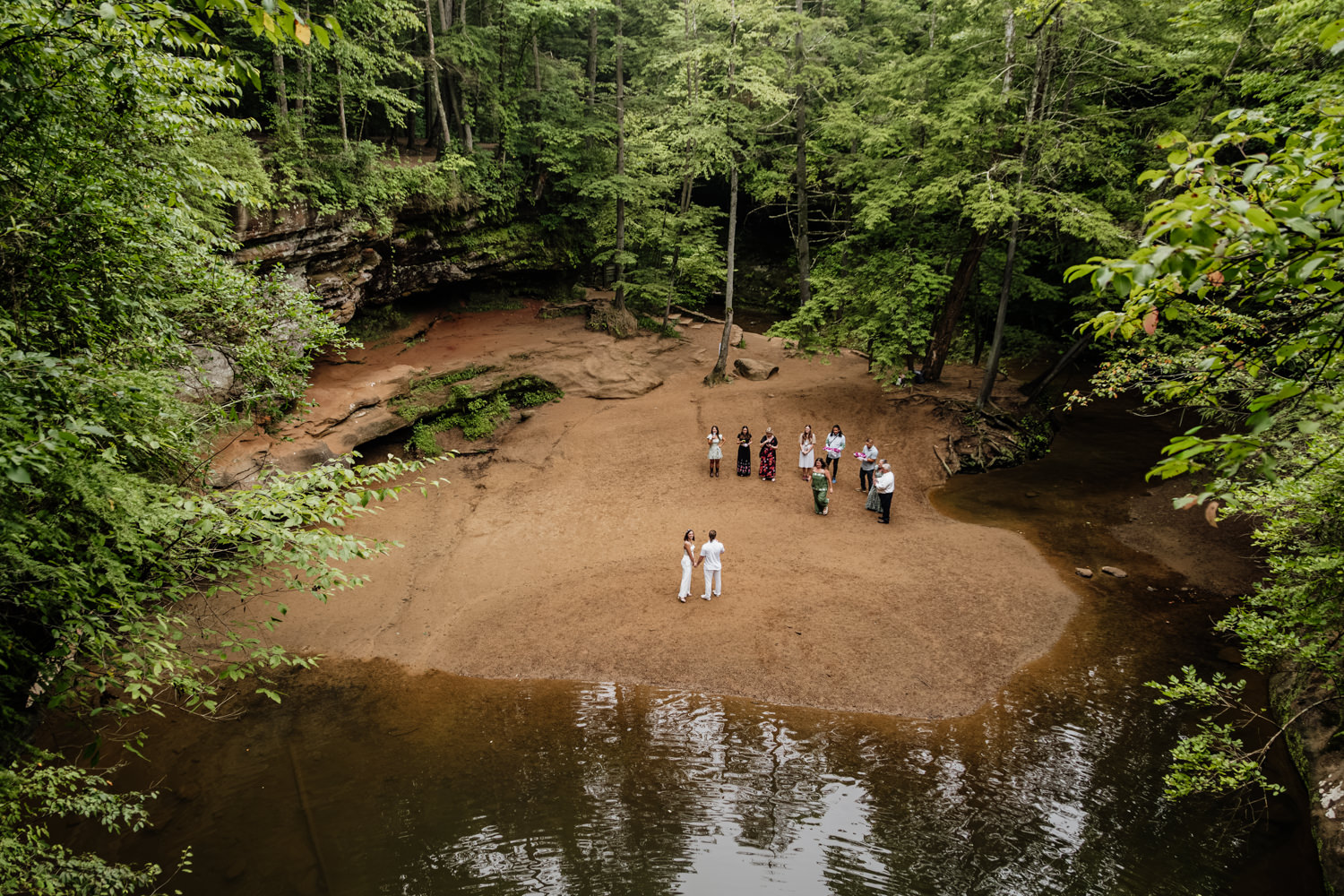 Emotional micro-wedding ceremony surrounded by massive sandstone cliffs and hemlocks.