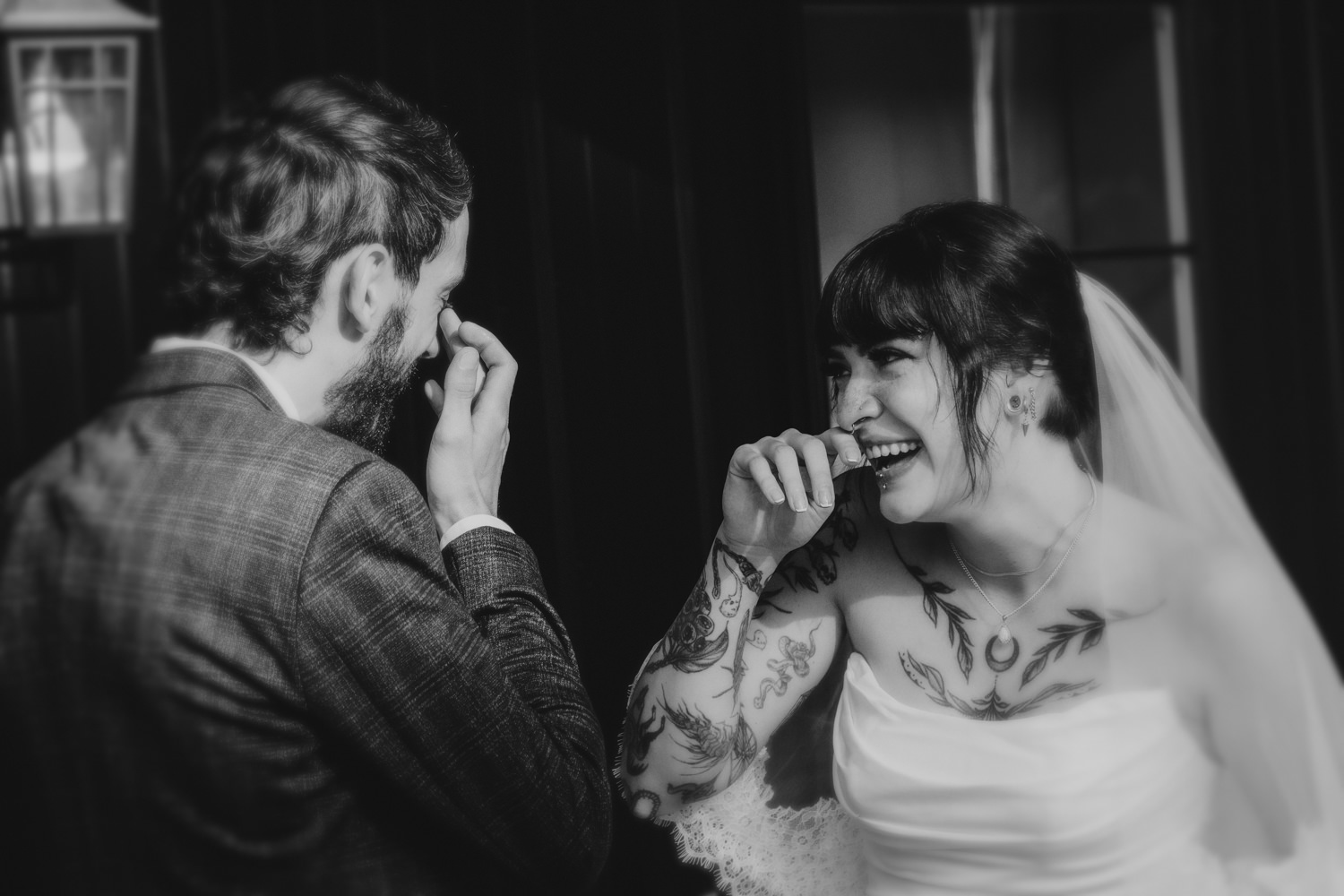 Bride and groom laughing together after their first look at a Hocking Hills cabin.
