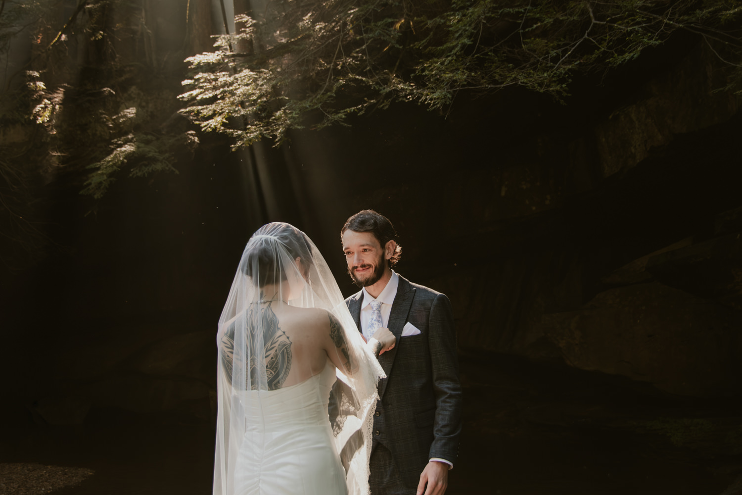 Couple whispering private vows to each other standing near the edge of the creekbed.