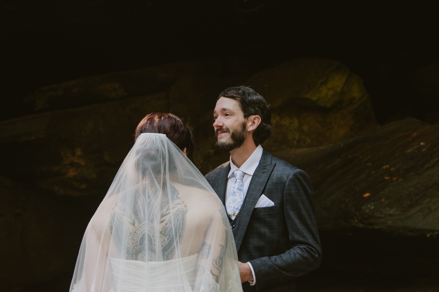 Couple whispering private vows to each other standing near the edge of the creekbed.