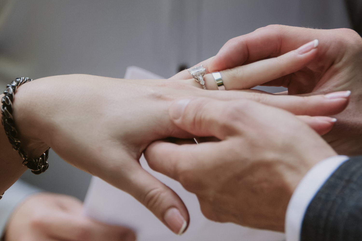 Bride and groom exchanging wedding rings during their micro wedding ceremony in Hocking Hills.