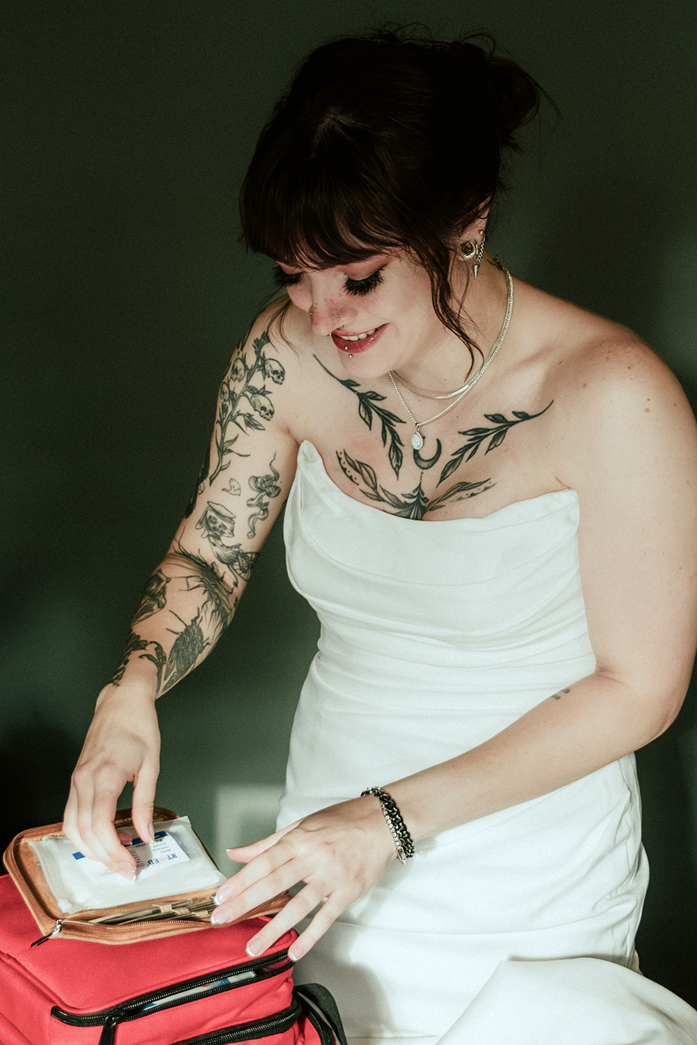 Trauma nurse bride using medical snips from her kit to trim loose threads on her wedding dress.