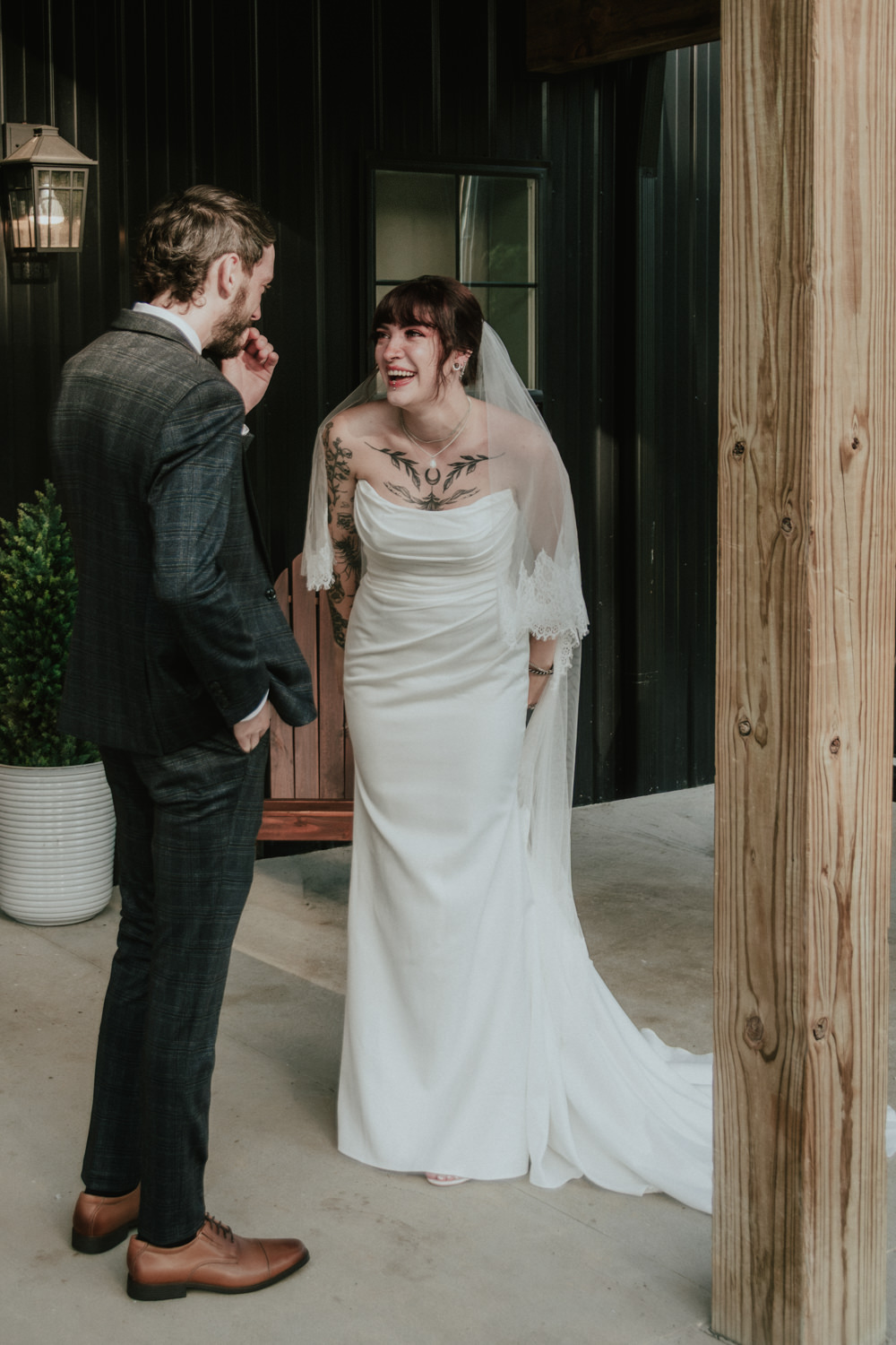 Bride and groom laughing together after their first look at a Hocking Hills cabin.