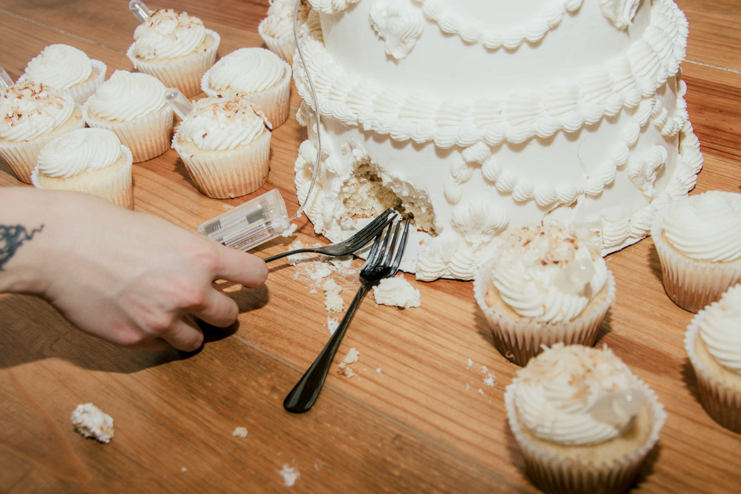 Hole in the back of a wedding cake where the couple took bites using forks.