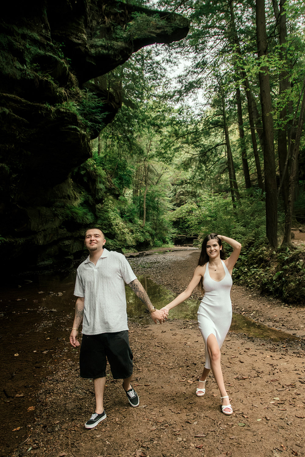 A couple walking down the historic carved stone staircase deep inside Old Man’s Cave gorge.