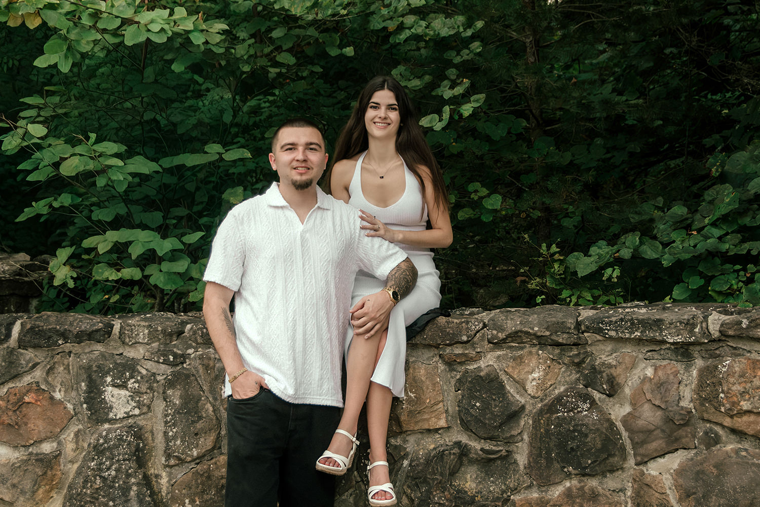 Close-up portrait of Alethia showing off her engagement ring while resting her hand on Anthony’s chest.