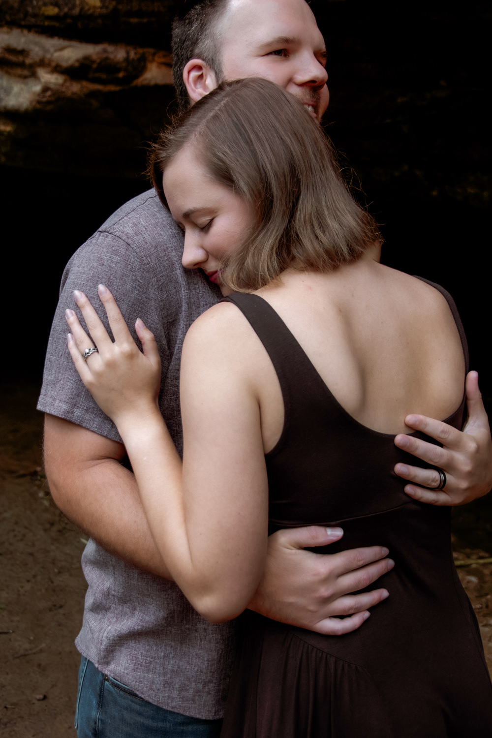 Close-up portrait of Mary Catherine and Jordan embracing during their 10th-anniversary session.