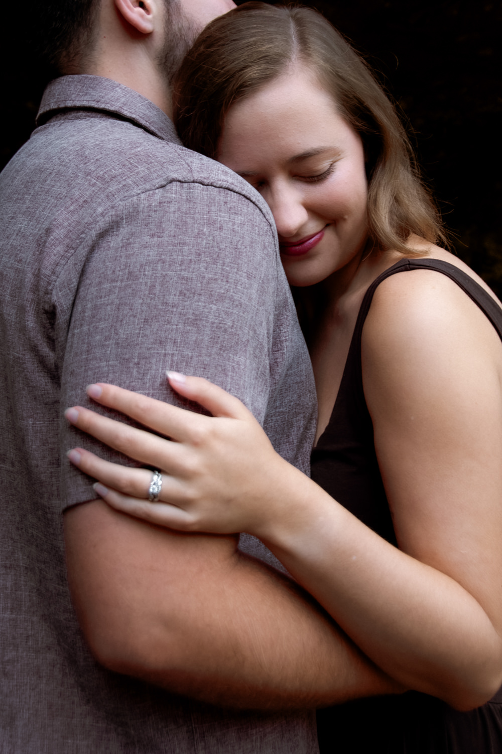 Close-up portrait of Mary Catherine and Jordan embracing during their 10th-anniversary session.