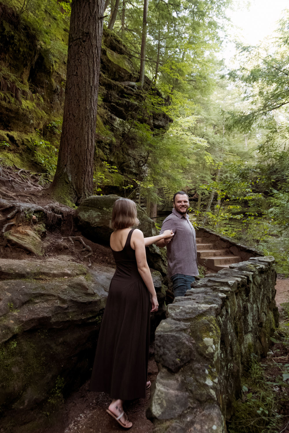 Final romantic shot of Mary Catherine and Jordan walking into the sunlit woods together.
