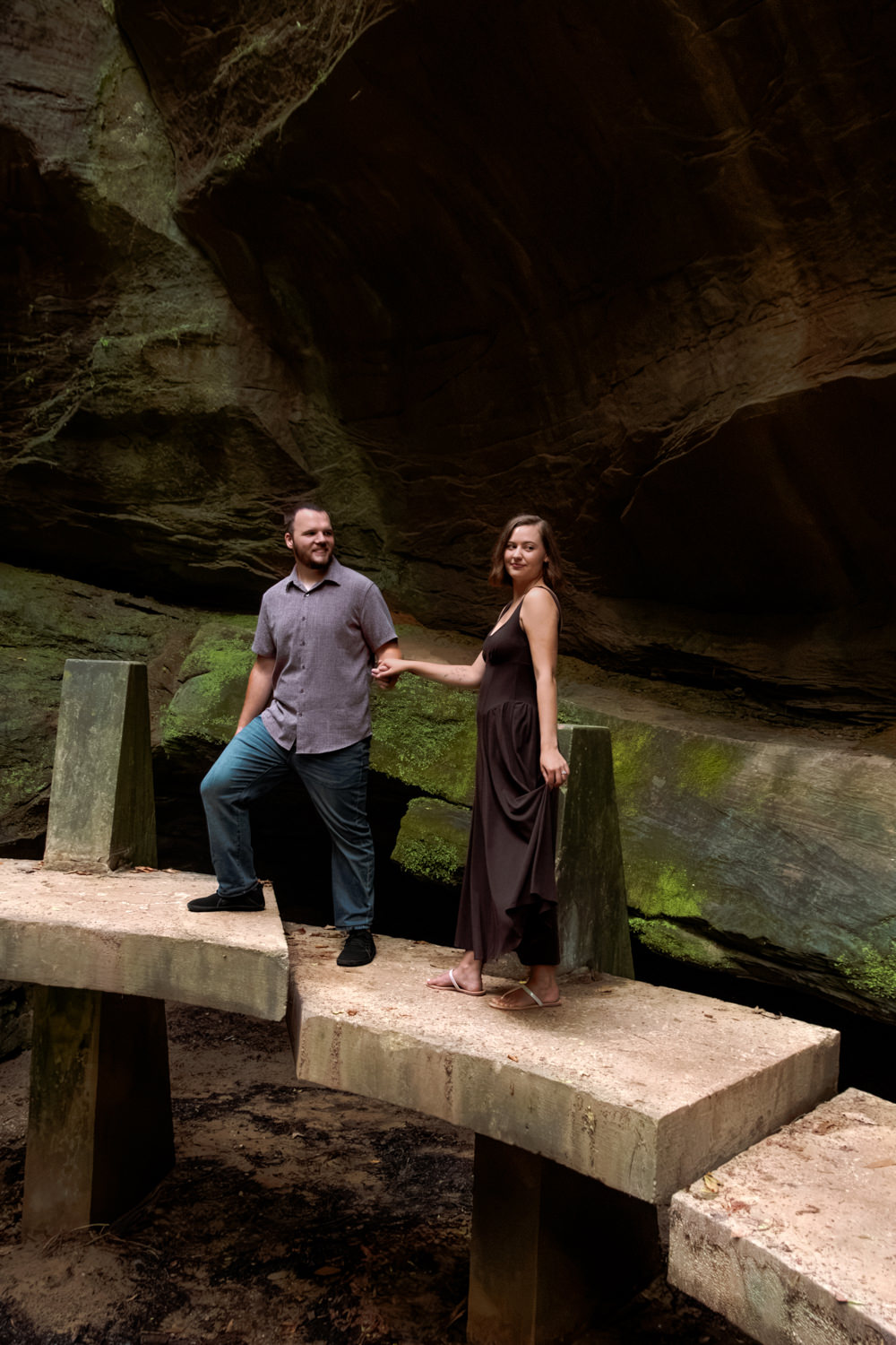 Couple walking together along the stone steps descending into the deep Hocking Hills gorge.