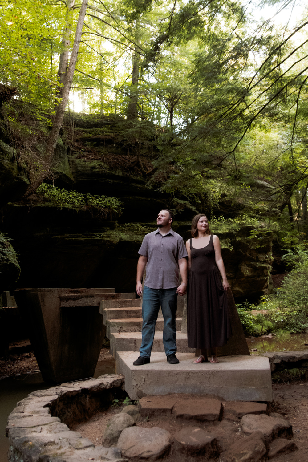 Couple walking together along the stone steps descending into the deep Hocking Hills gorge.