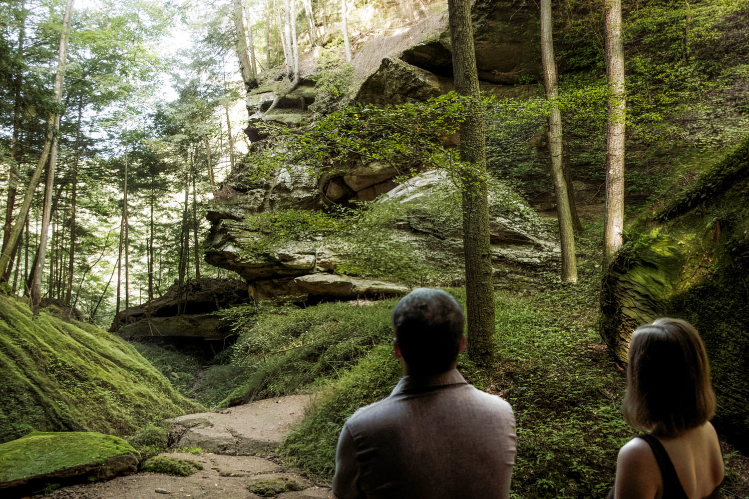 Wide shot of a couple exploring hidden rock formations like the Sphinx Head in the gorge.