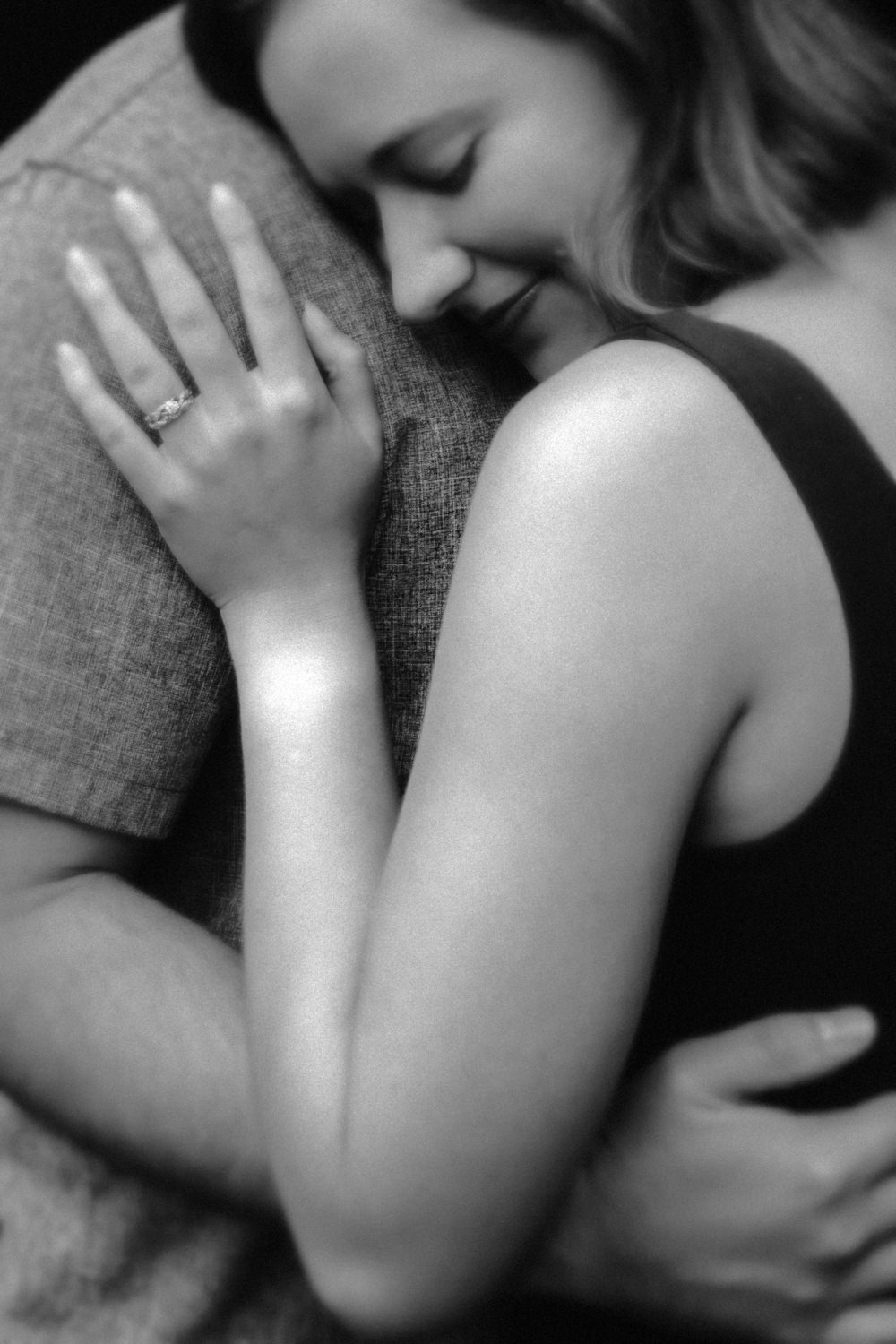 Close-up portrait of Mary Catherine and Jordan embracing during their 10th-anniversary session.