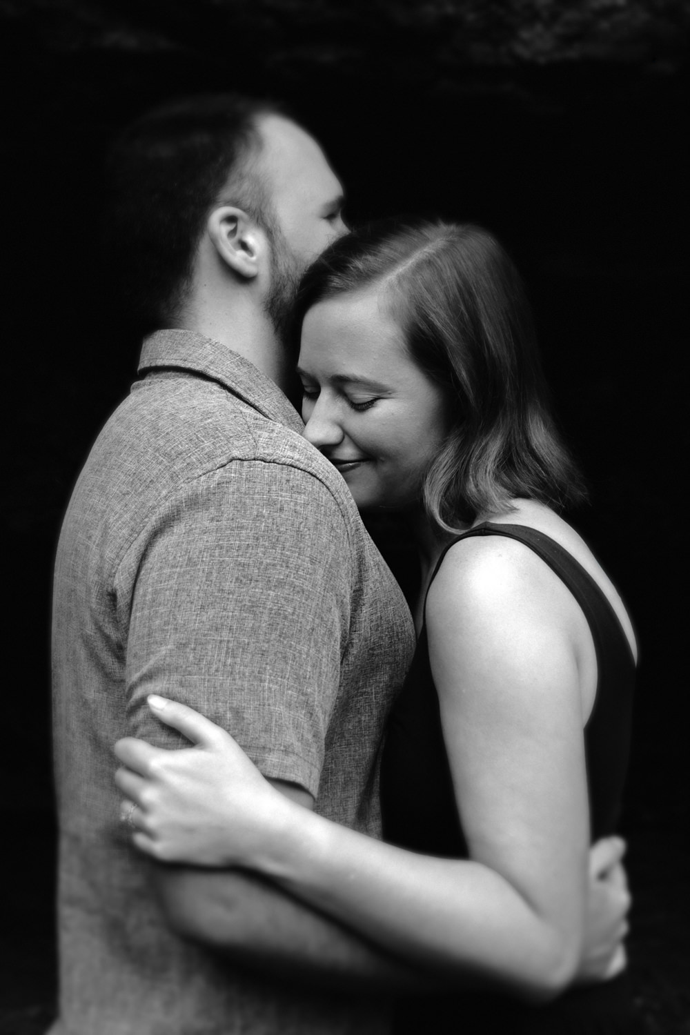 Close-up portrait of Mary Catherine and Jordan embracing during their 10th-anniversary session.